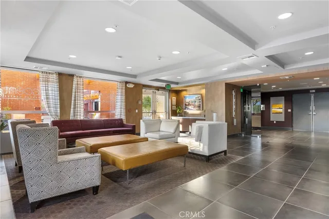 a living room with furniture and large windows