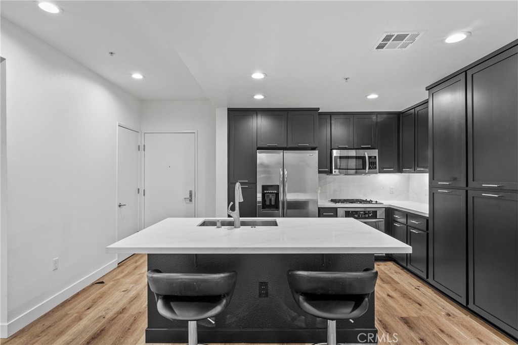 21301 Erwin Street, Unit 206 Woodland Hills, CA 91367 - Photo 3 of 34 a kitchen with a table and chairs