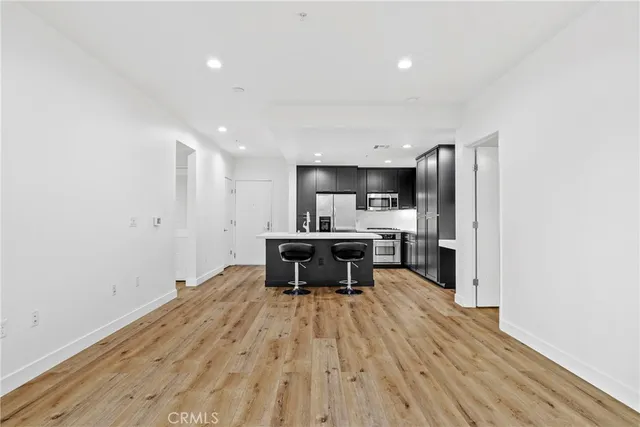 a kitchen with a sink stainless steel appliances and cabinets