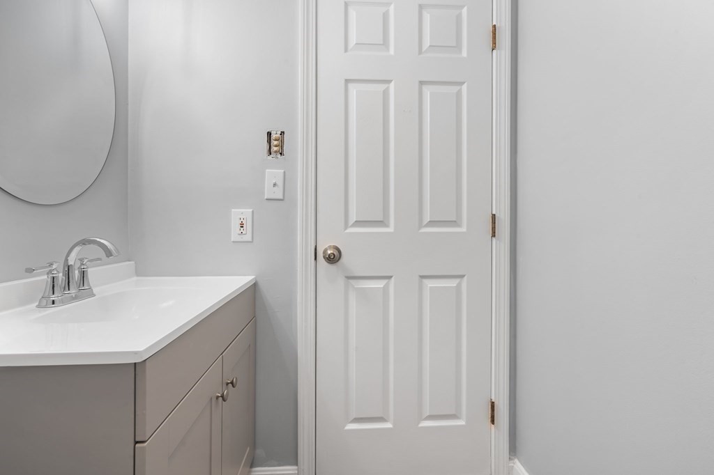 20 Rockland House Road, Unit 402 Hull, MA 02045 - Photo 13 of 40 a bathroom with a sink vanity and a mirror