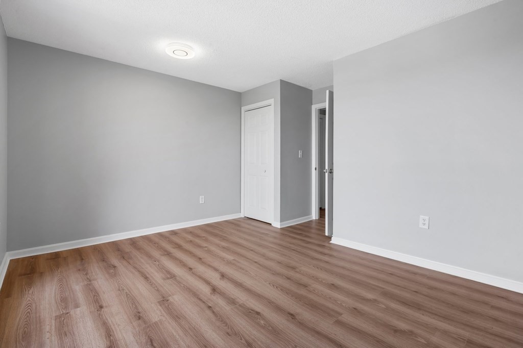 20 Rockland House Road, Unit 402 Hull, MA 02045 - Photo 16 of 40 a view of an empty room with wooden floor