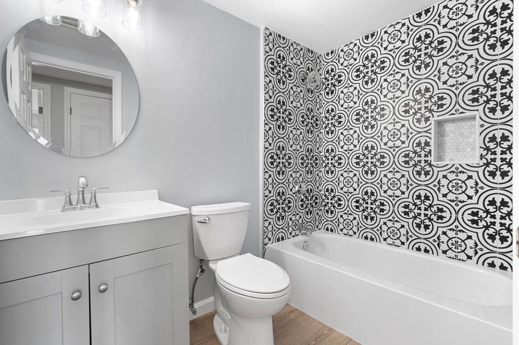 20 Rockland House Road, Unit 402 Hull, MA 02045 - Photo 18 of 40 a bathroom with a sink toilet and a mirror