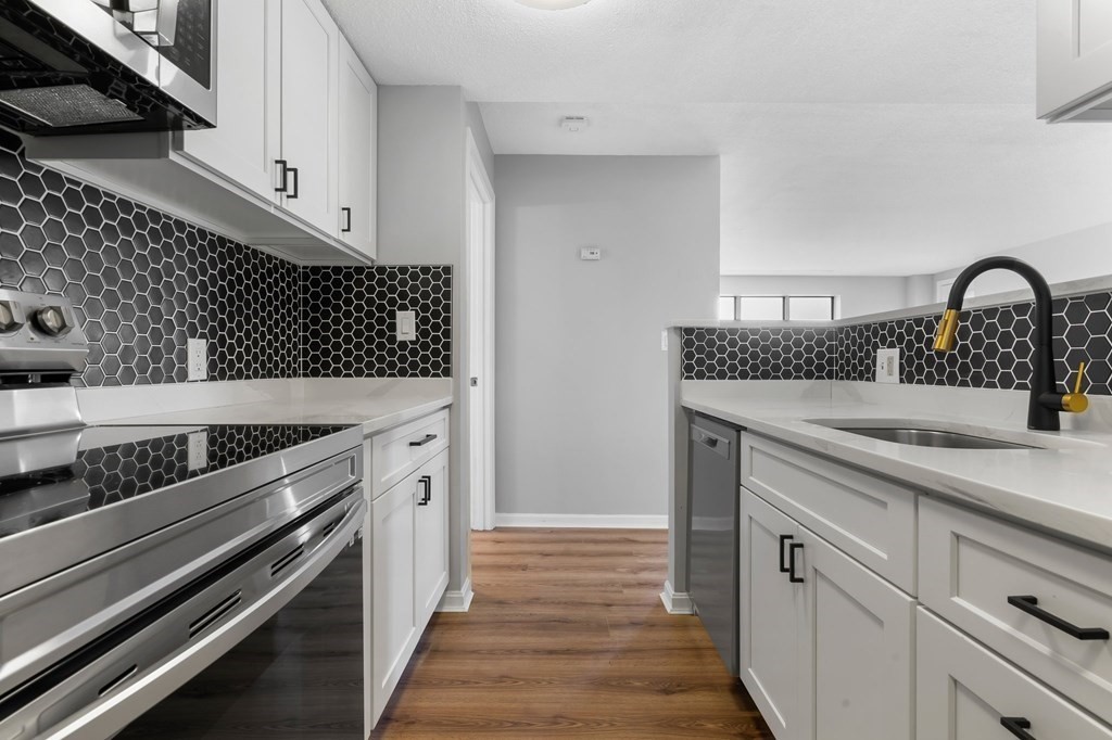 20 Rockland House Road, Unit 402 Hull, MA 02045 - Photo 2 of 40 a kitchen with a sink and cabinets