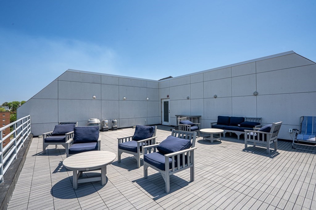 20 Rockland House Road, Unit 402 Hull, MA 02045 - Photo 26 of 40 a patio with patio a couch and chairs