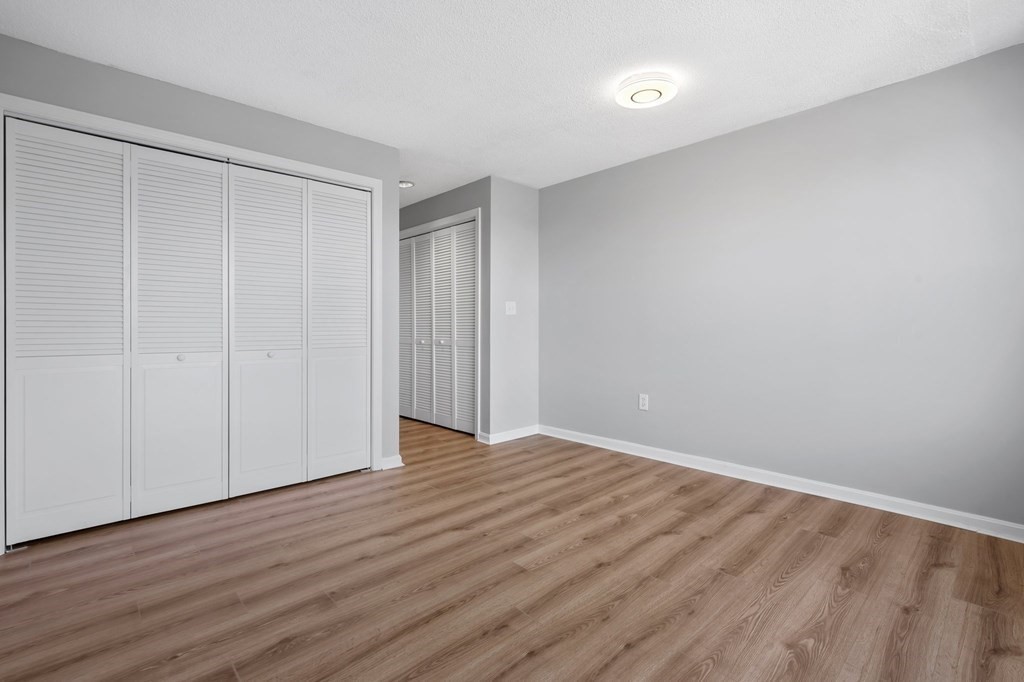 20 Rockland House Road, Unit 402 Hull, MA 02045 - Photo 9 of 40 a view of an empty room with wooden floor