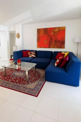 a living room with a couch and rug