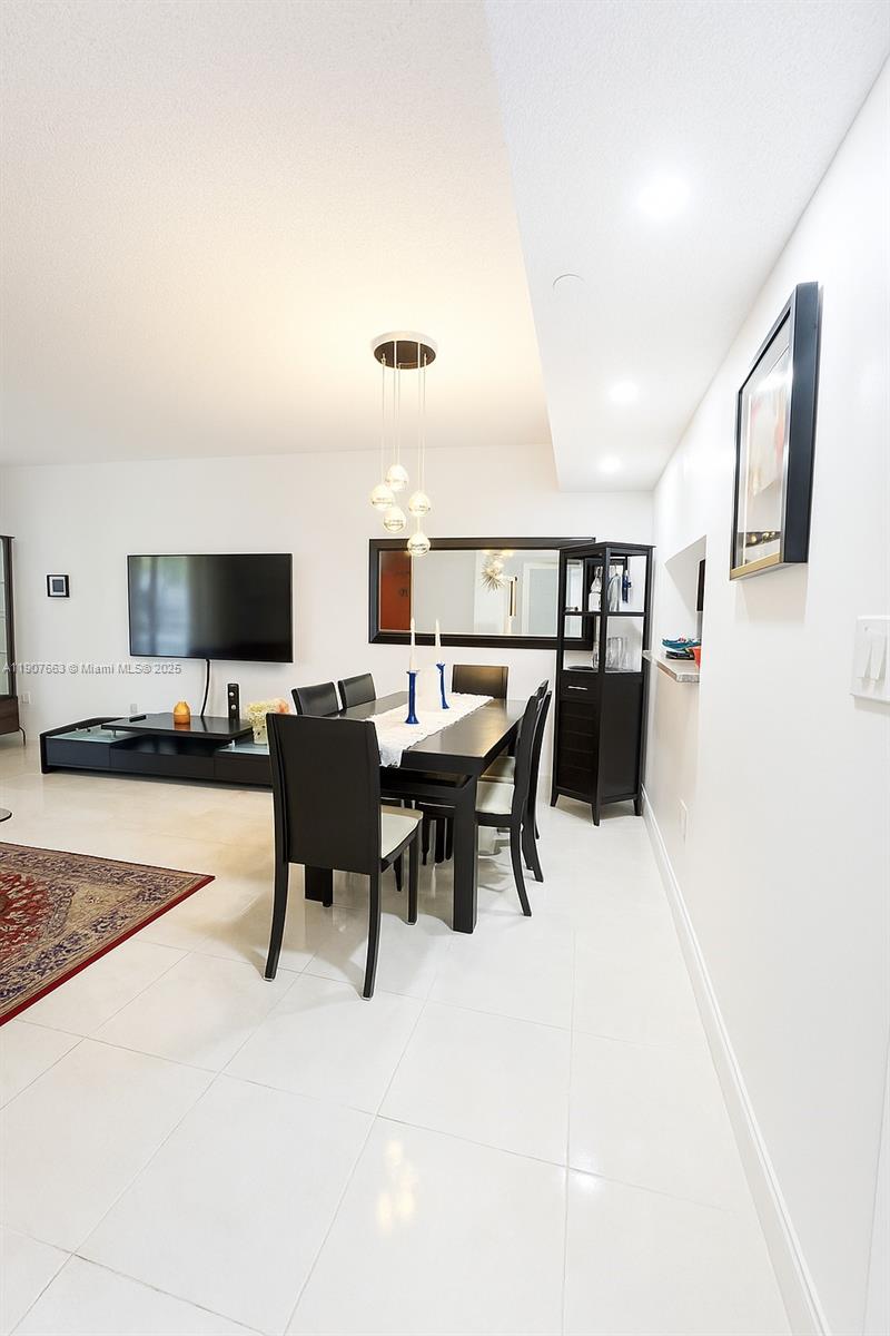 8730 Southwest 133rd Avenue Road, Unit 101 Miami, FL 33183 - Photo 3 of 9 a living room with furniture and a flat screen tv