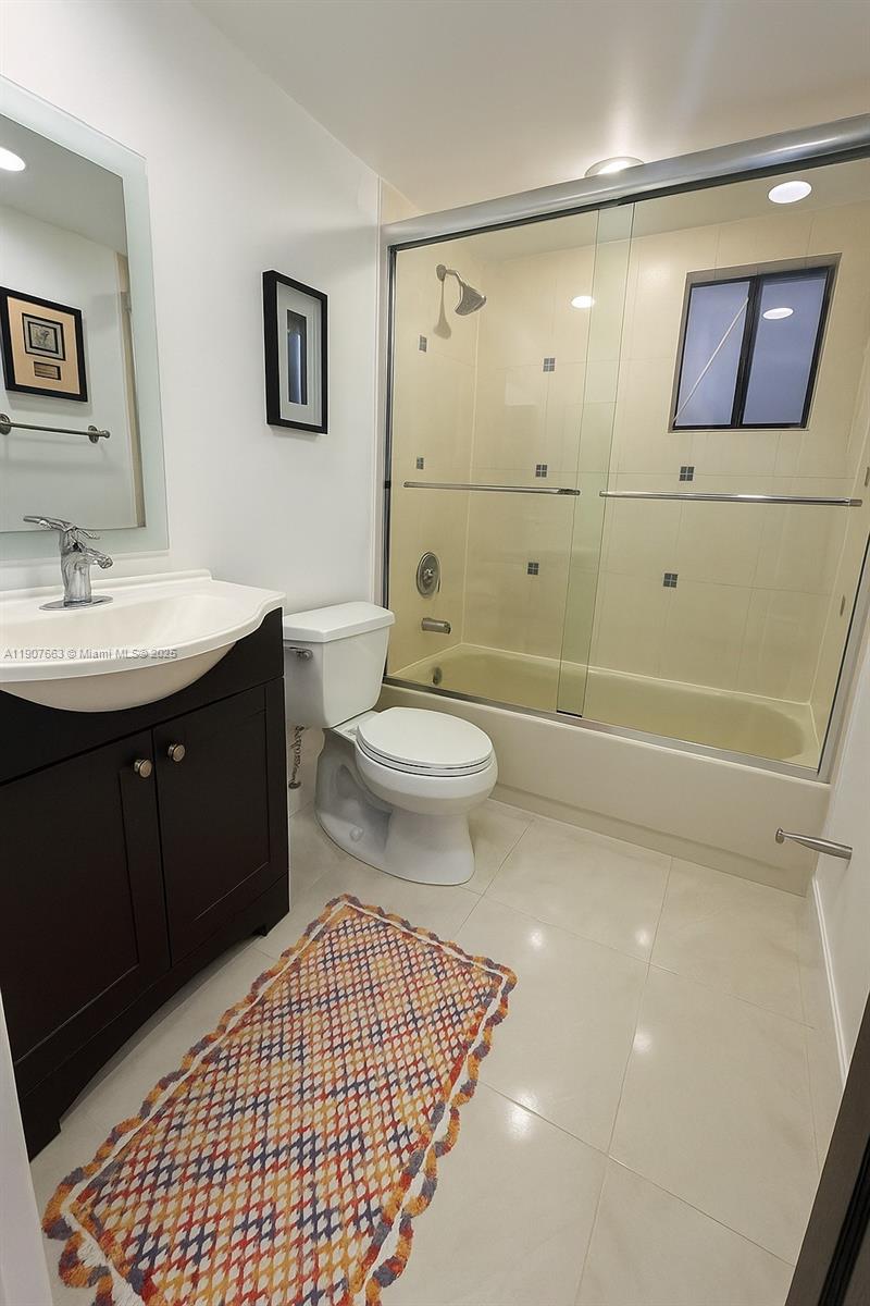 8730 Southwest 133rd Avenue Road, Unit 101 Miami, FL 33183 - Photo 5 of 9 a bathroom with a sink a toilet and shower