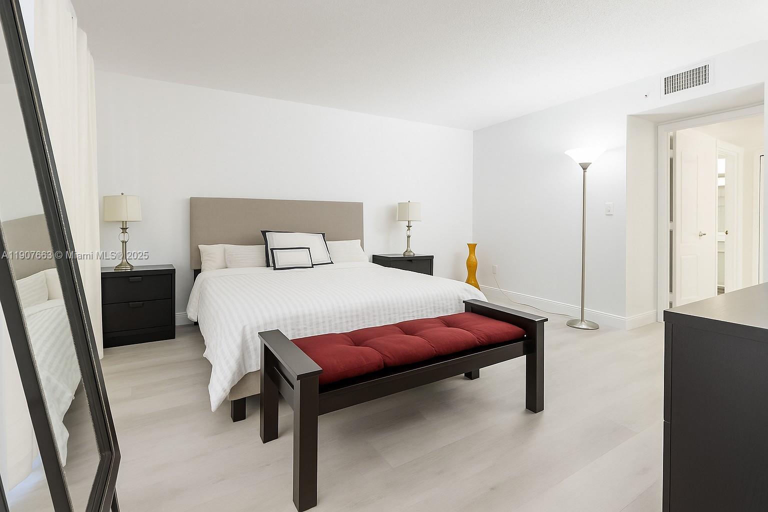 8730 Southwest 133rd Avenue Road, Unit 101 Miami, FL 33183 - Photo 6 of 9 a bedroom with a bed and a dresser