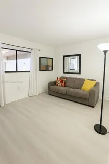 a living room with furniture and window