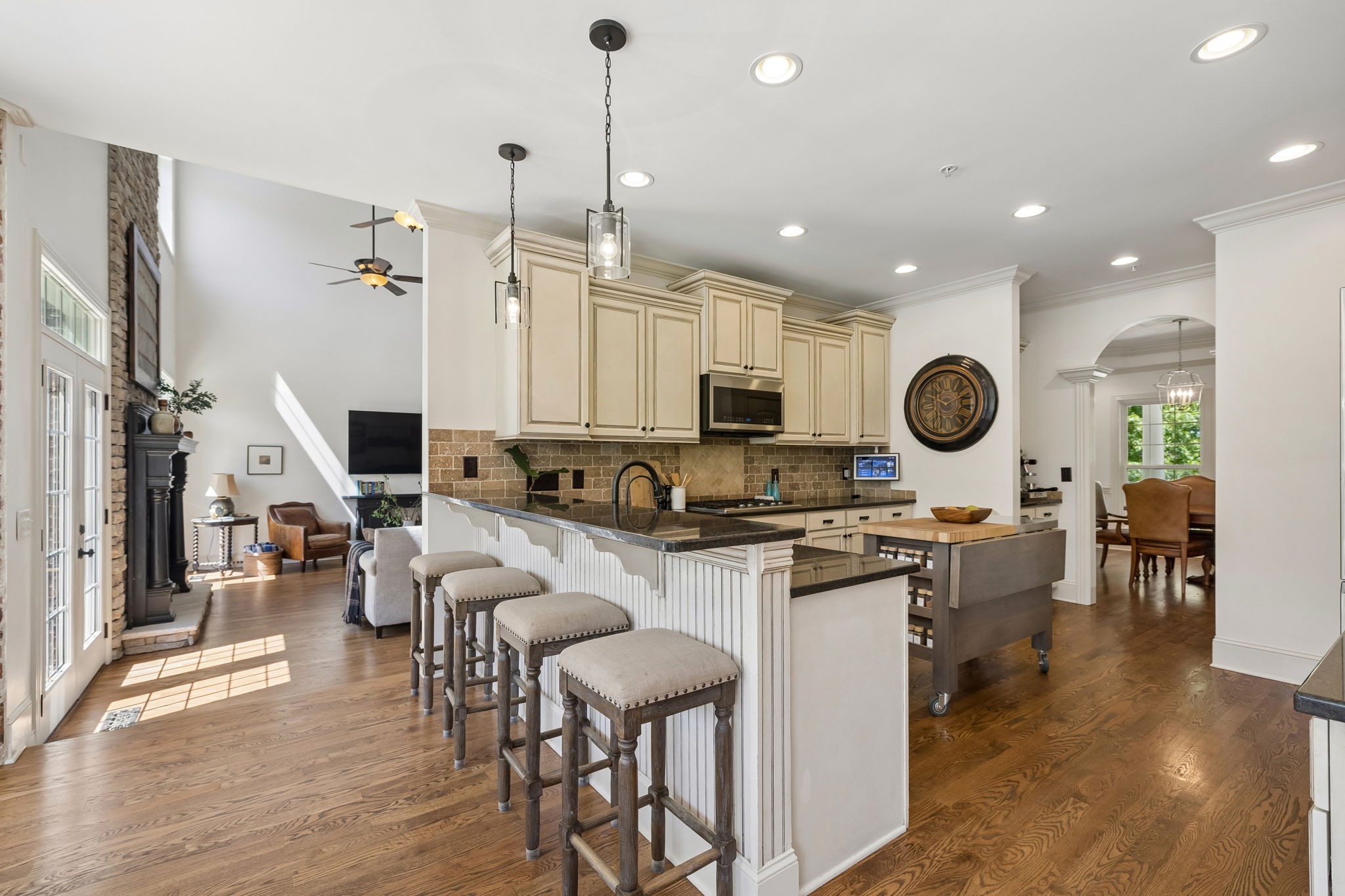 911 Bluff Road Brentwood, TN 37027 - Photo 15 of 61 a open kitchen with stainless steel appliances granite countertop a stove top oven a sink dishwasher a dining table and chairs with wooden floor