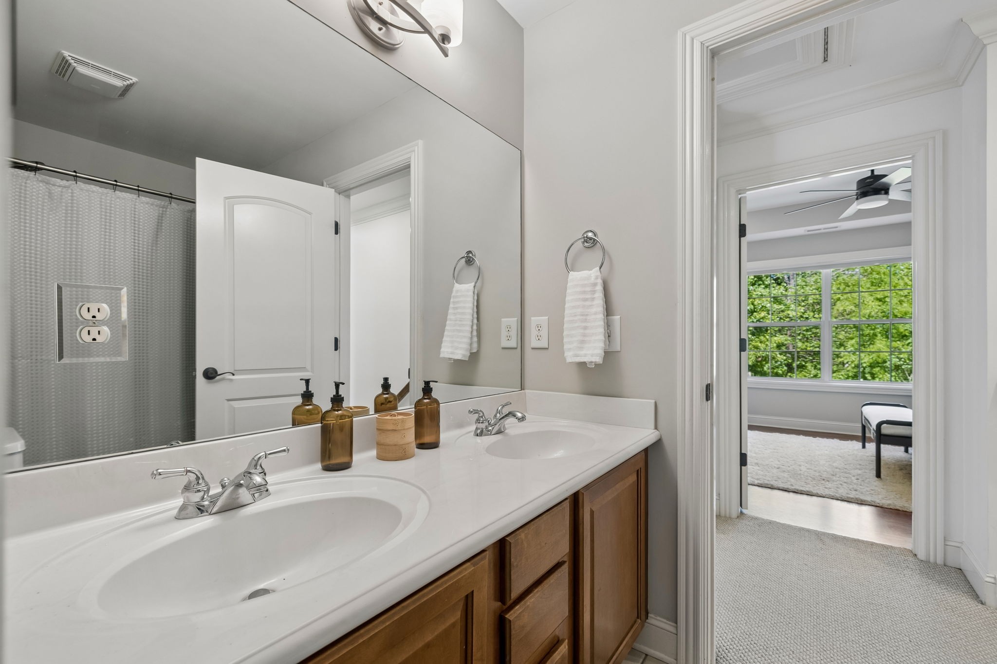 911 Bluff Road Brentwood, TN 37027 - Photo 27 of 61 a bathroom with a double vanity sink a mirror and a bathtub