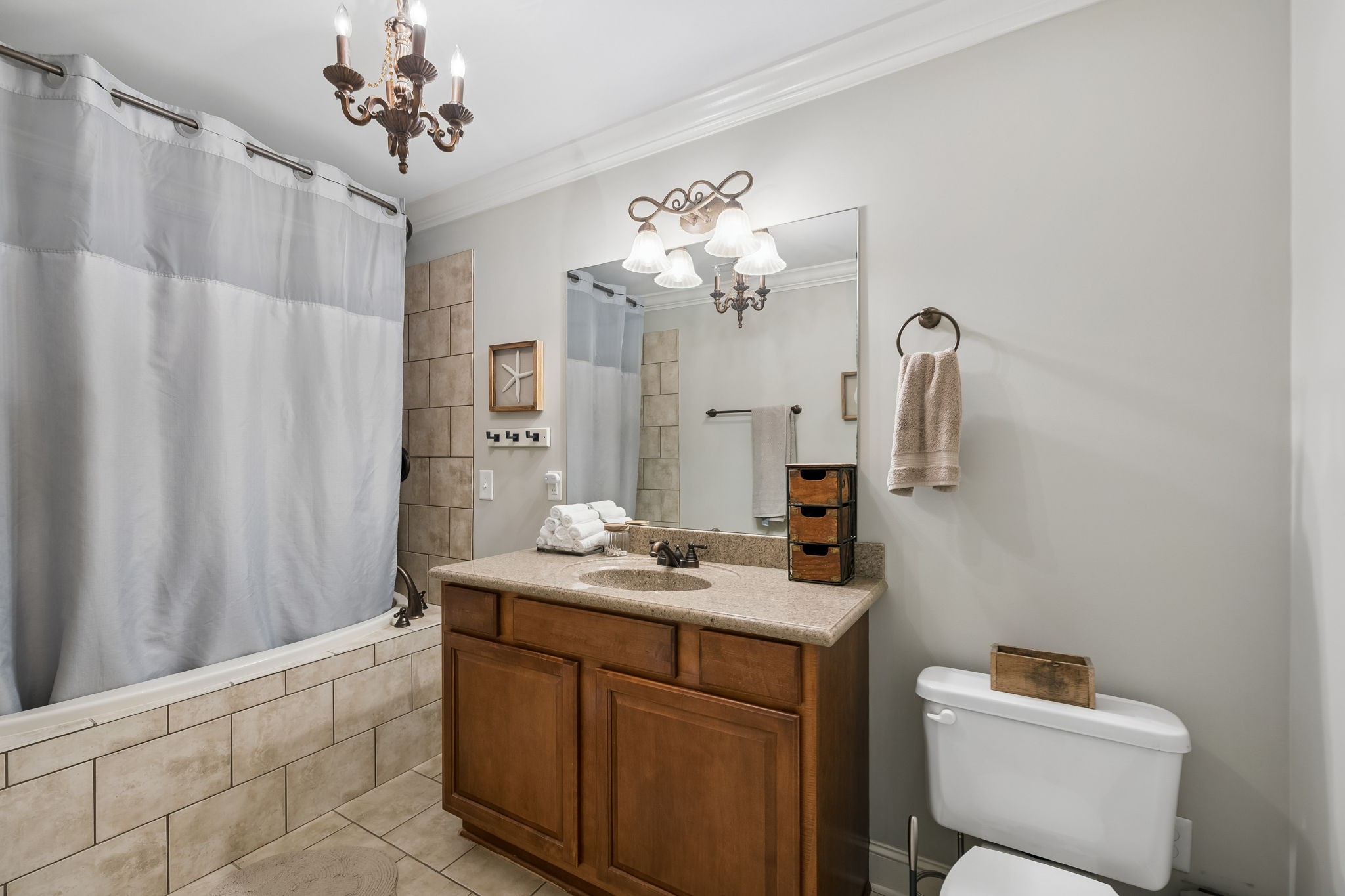 911 Bluff Road Brentwood, TN 37027 - Photo 31 of 61 a bathroom with a sink a mirror and a shower curtain