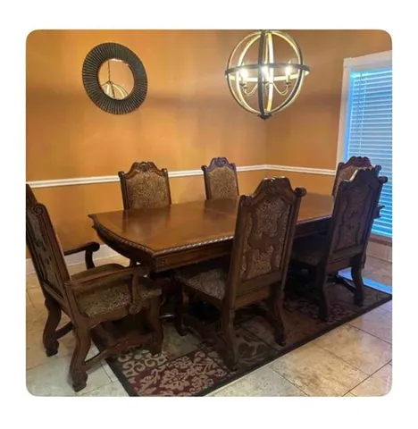 a view of a dining room with furniture and chandelier
