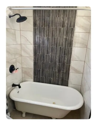 a bathroom with a bathtub and shower