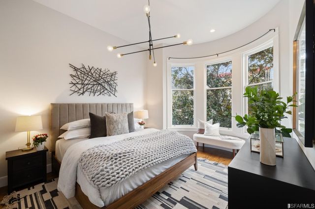 a bedroom with a bed window and couch