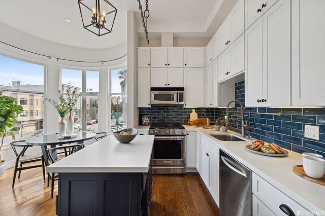 a kitchen with a sink a stove a microwave and cabinets