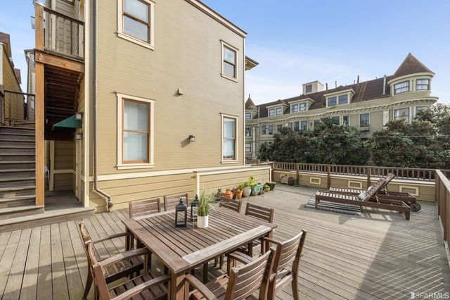 a view of a patio with couches table and chairs and potted plants