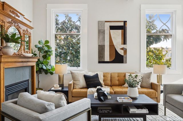 a living room with furniture potted plant and a fireplace