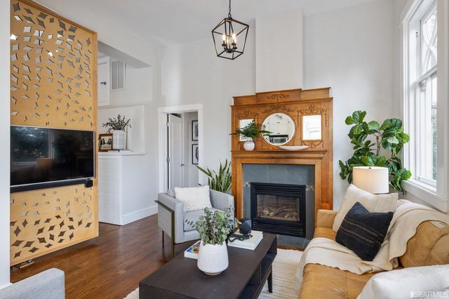 a living room with furniture a fireplace and a flat screen tv