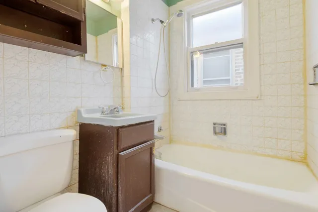 a bathroom with a bathtub toilet and sink