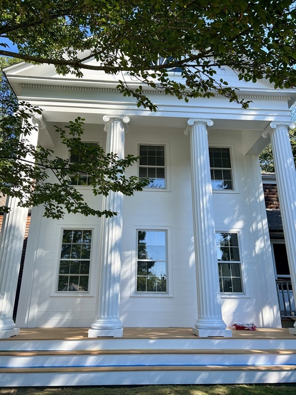 a view of a house with potted plants