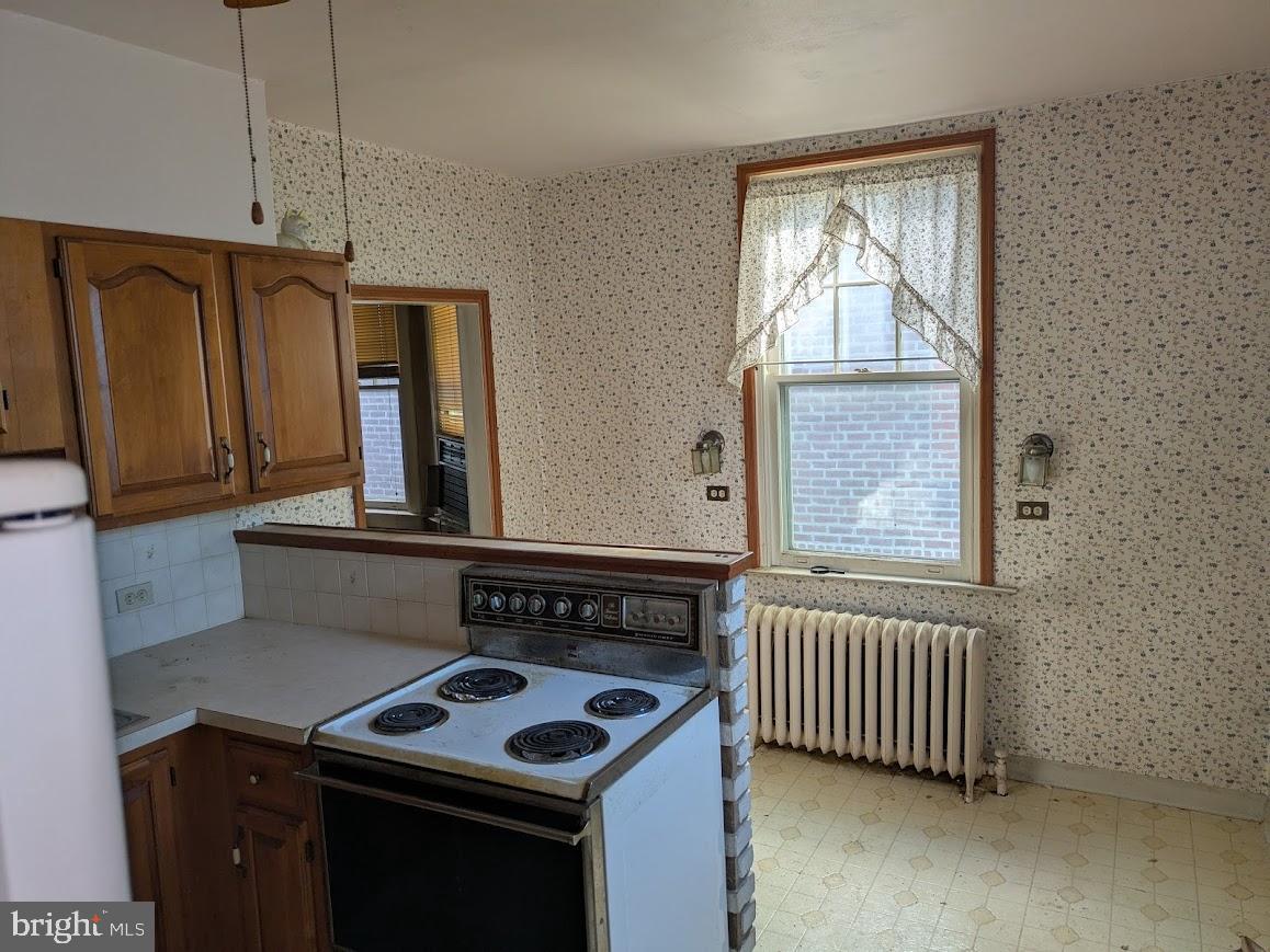 817 Passmore Street Philadelphia, PA 19111 - Photo 11 of 16 a kitchen that has a stove and a window