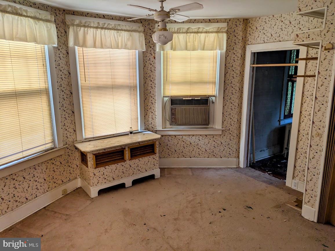 817 Passmore Street Philadelphia, PA 19111 - Photo 14 of 16 a view of an empty room with a fireplace and a window