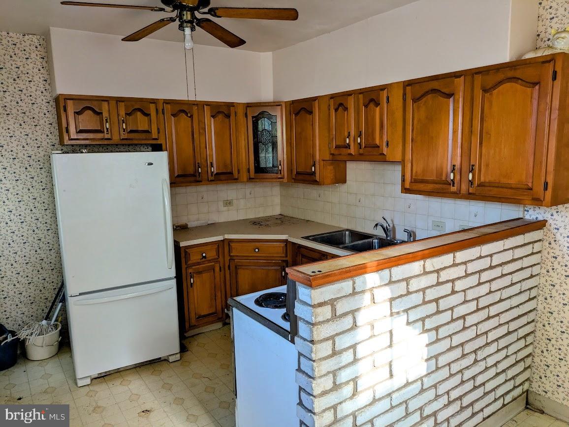 817 Passmore Street Philadelphia, PA 19111 - Photo 10 of 16 a kitchen with stainless steel appliances granite countertop a refrigerator and a stove top oven