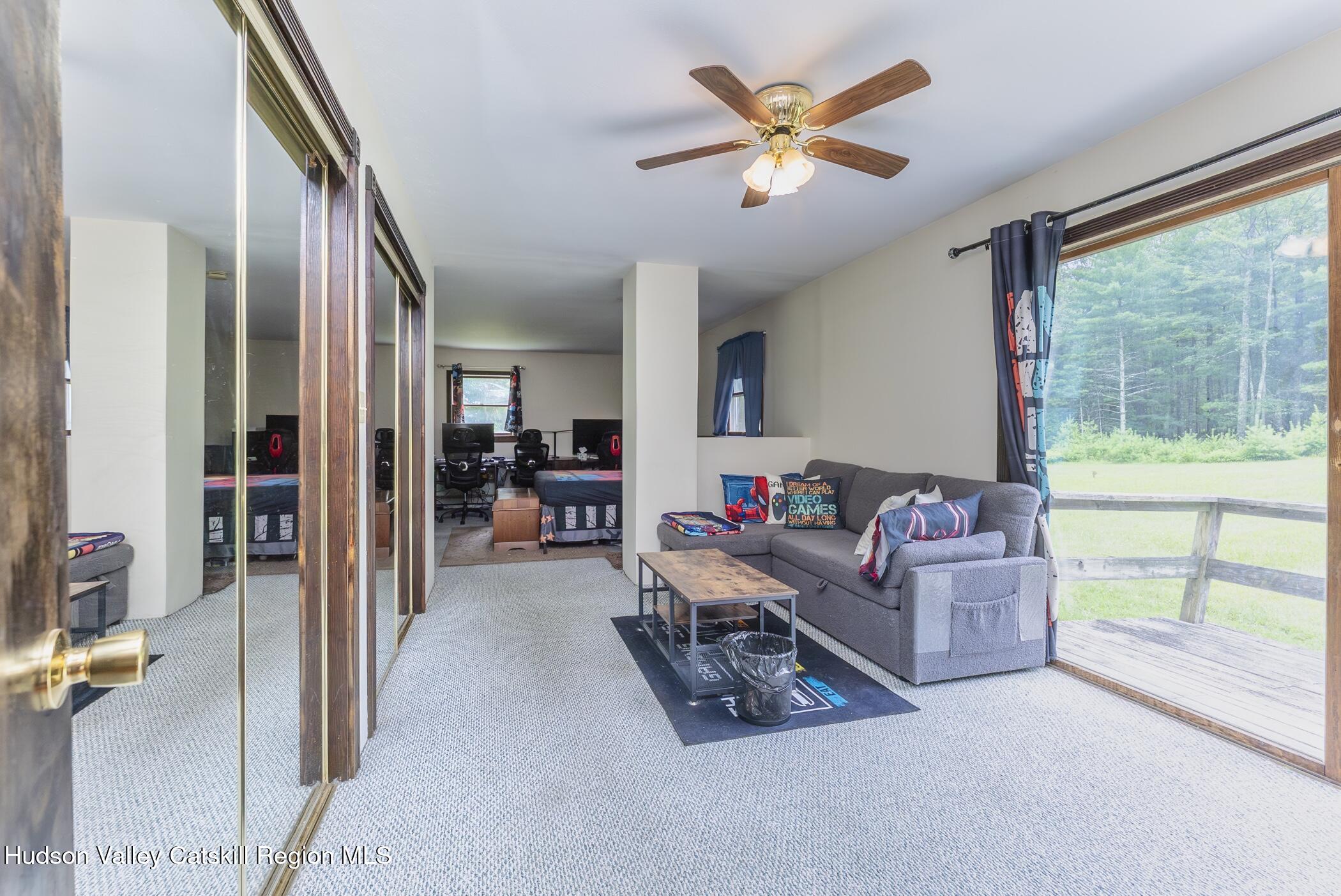 137 Bush Road Stone Ridge, NY 12484 - Photo 17 of 39 a living room with furniture and a large window