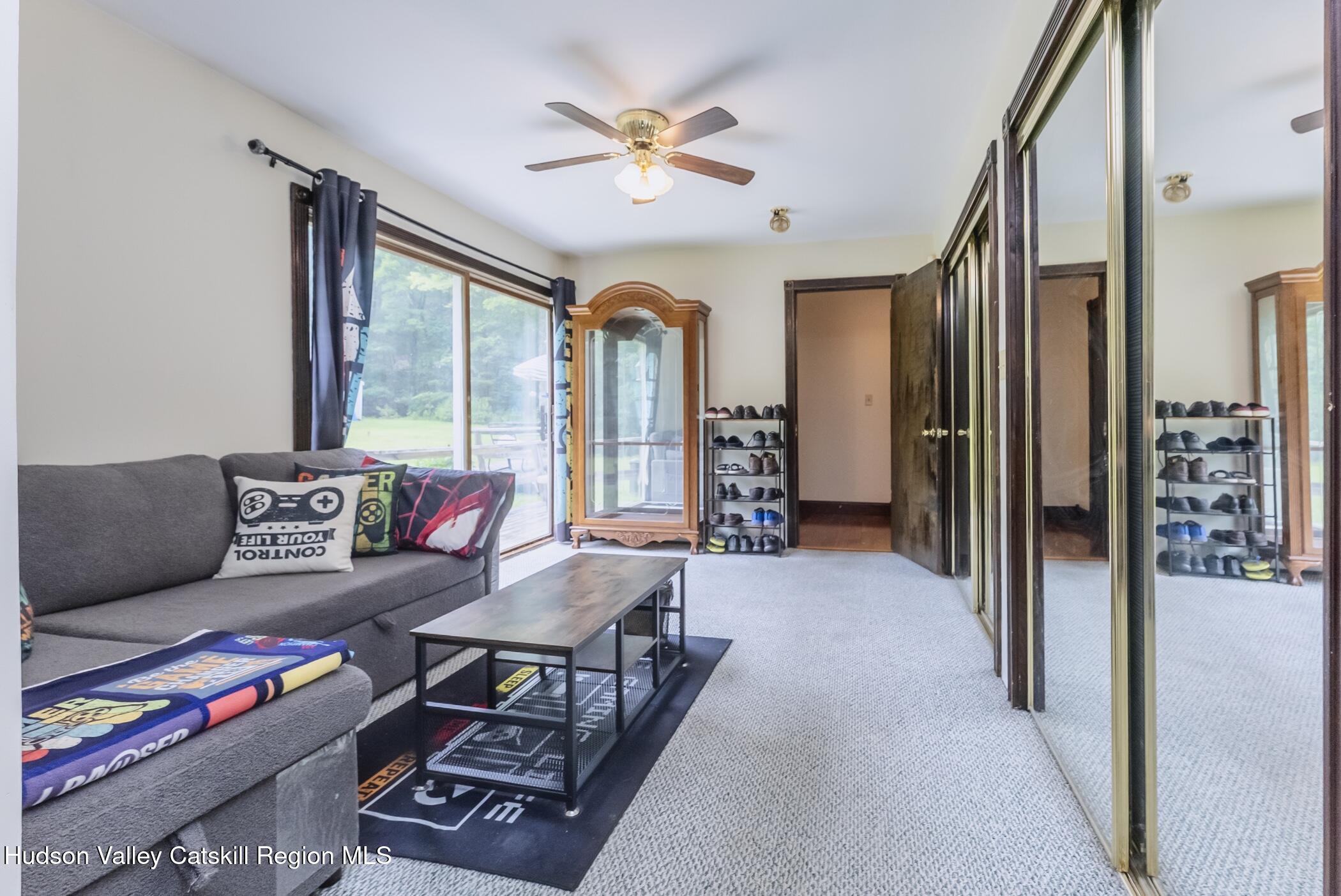 137 Bush Road Stone Ridge, NY 12484 - Photo 18 of 39 a living room with furniture and a large window