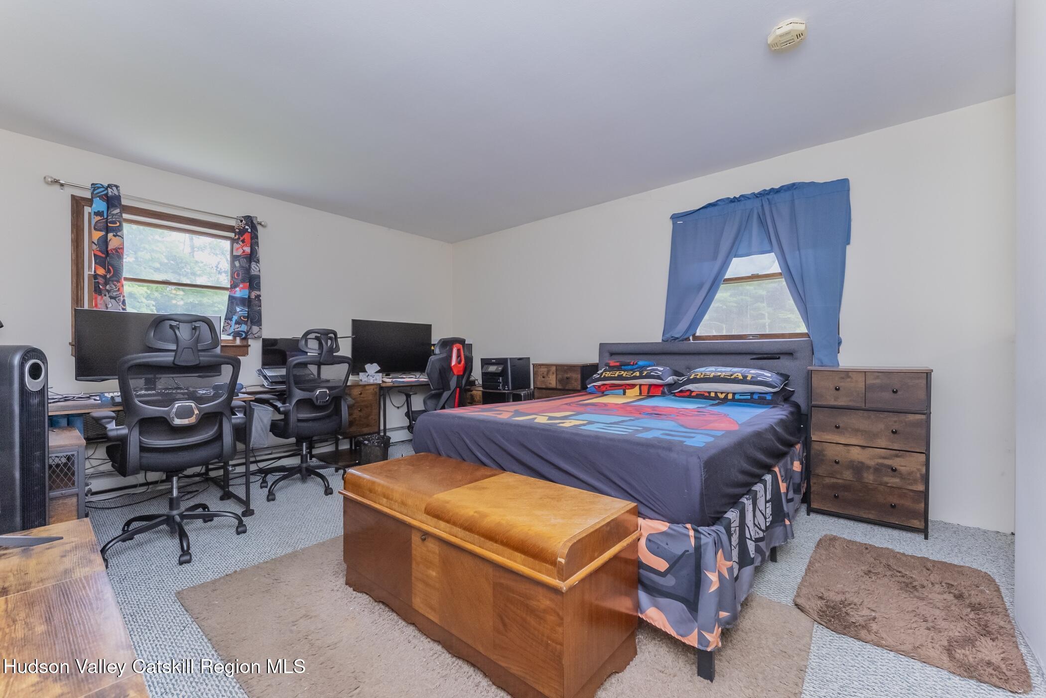 137 Bush Road Stone Ridge, NY 12484 - Photo 19 of 39 a bedroom with a bed a desk and chair