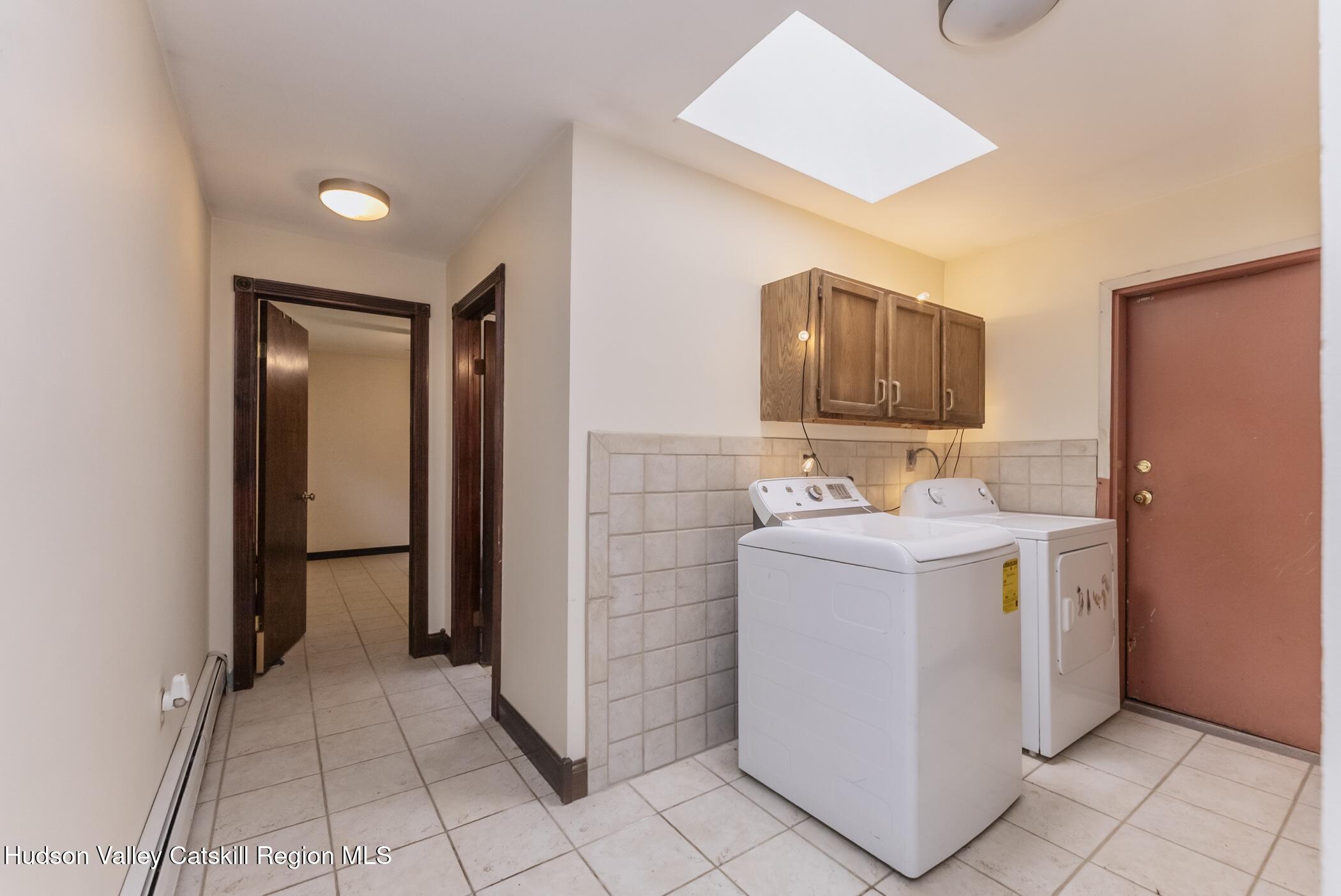 137 Bush Road Stone Ridge, NY 12484 - Photo 24 of 39 a utility room with cabinets washer and dryer