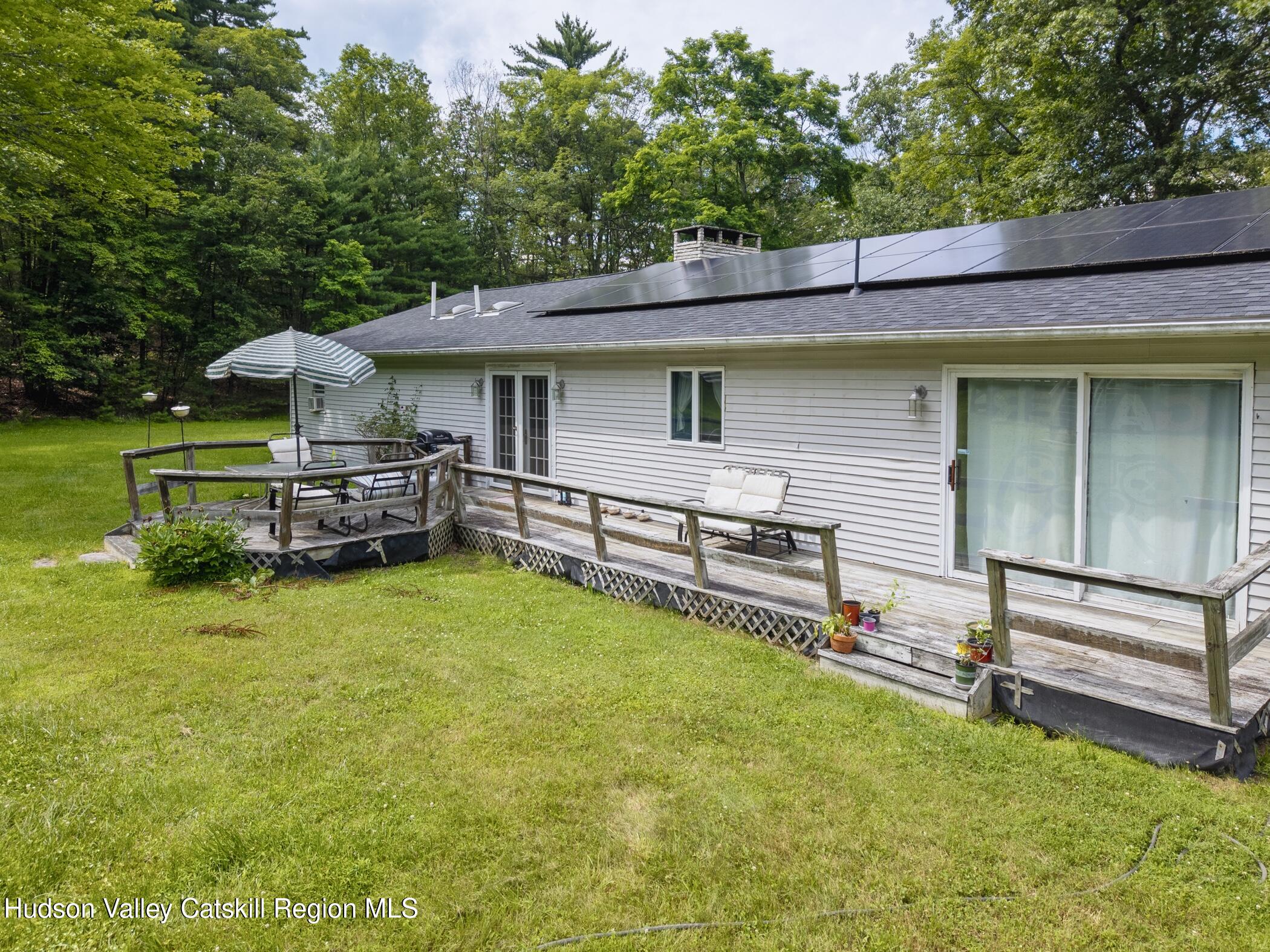 137 Bush Road Stone Ridge, NY 12484 - Photo 30 of 39 a view of a house with a yard and sitting area