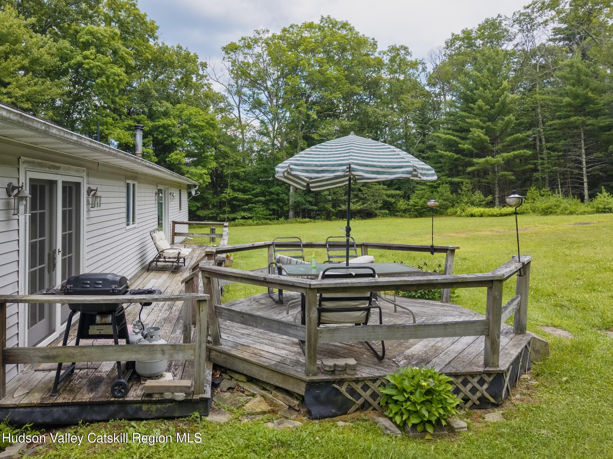 137 Bush Road Stone Ridge, NY 12484 - Photo 31 of 39 a view of backyard with deck and outdoor seating