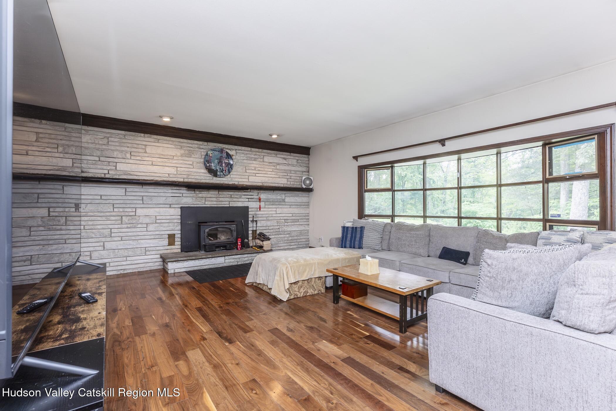 137 Bush Road Stone Ridge, NY 12484 - Photo 7 of 39 a living room with furniture and a fireplace