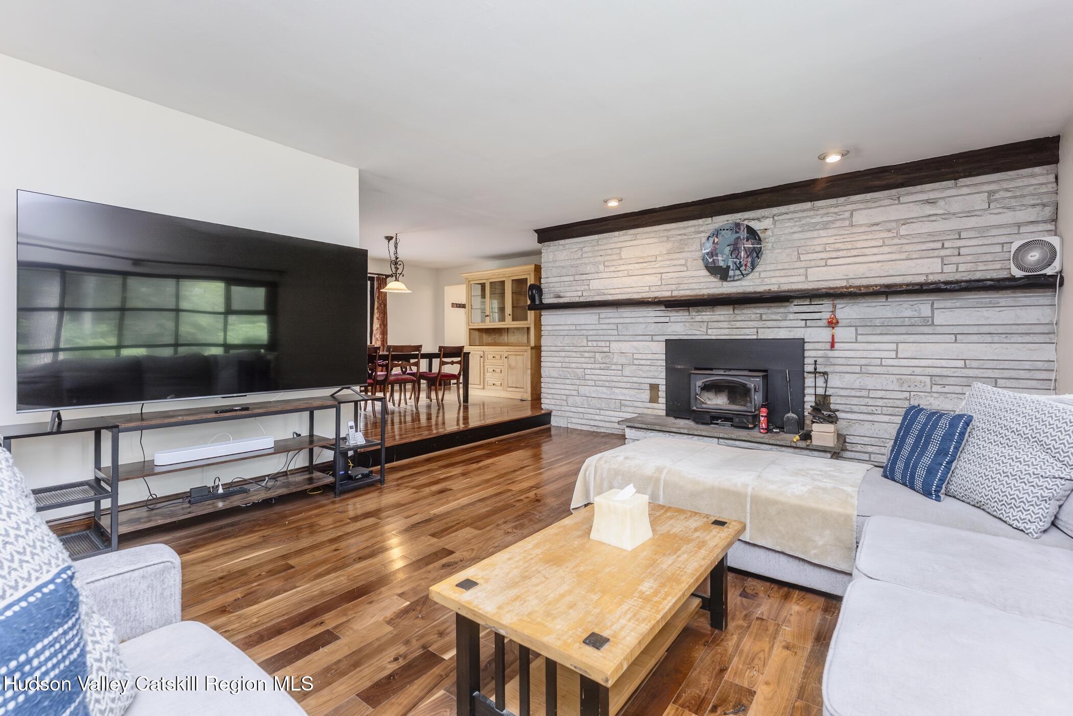 137 Bush Road Stone Ridge, NY 12484 - Photo 8 of 39 a living room with furniture and a fireplace