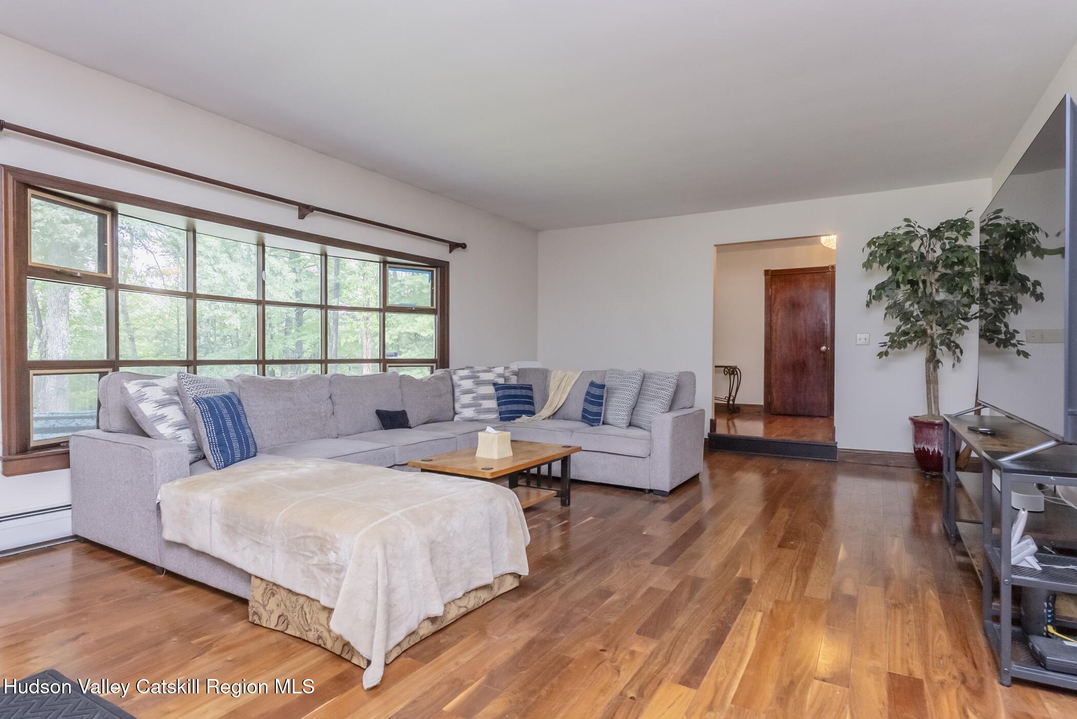 137 Bush Road Stone Ridge, NY 12484 - Photo 9 of 39 a bedroom with a bed a table and chair