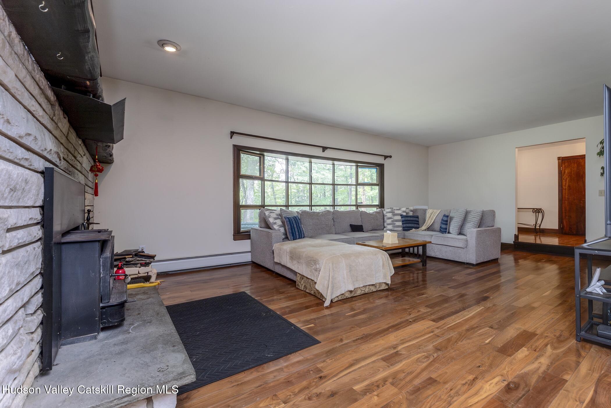 137 Bush Road Stone Ridge, NY 12484 - Photo 10 of 39 a bed room with furniture and a wooden floor