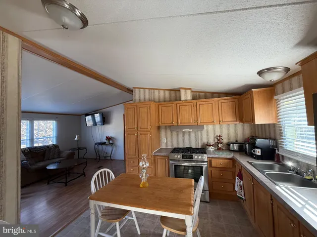 a kitchen with sink cabinets and wooden floor