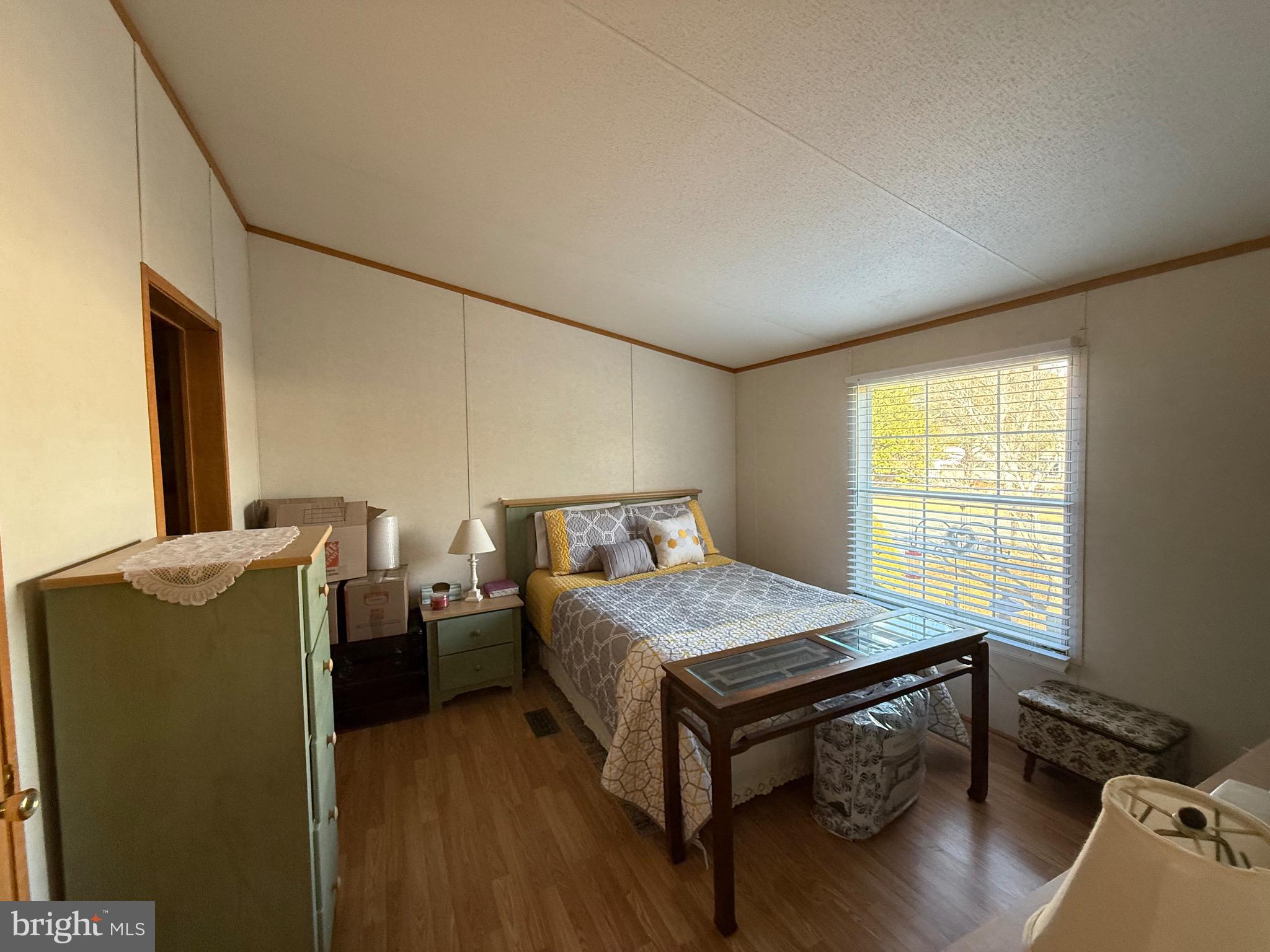 10323 Henry Road Berlin, MD 21811 - Photo 16 of 19 a bedroom with a bed and wooden floor