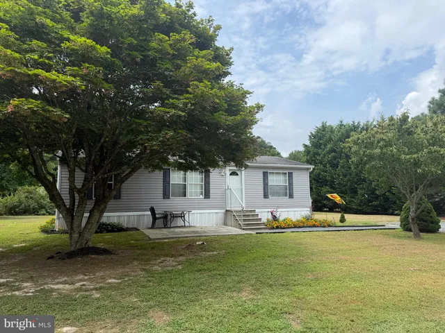 a house view with swimming pool and trees