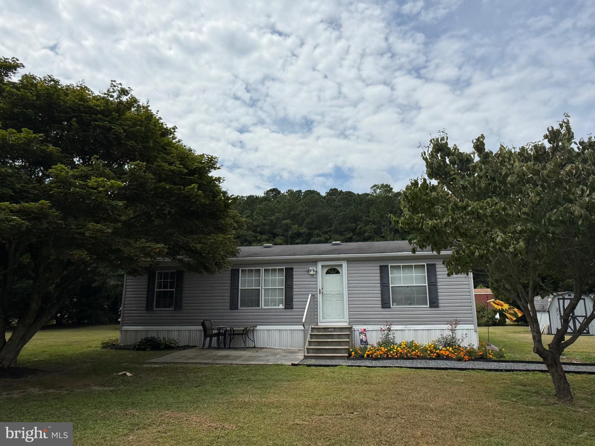 10323 Henry Road Berlin, MD 21811 - Photo 10 of 19 a front view of a house with a garden and trees