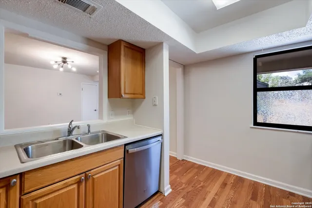 a kitchen with a sink and cabinets