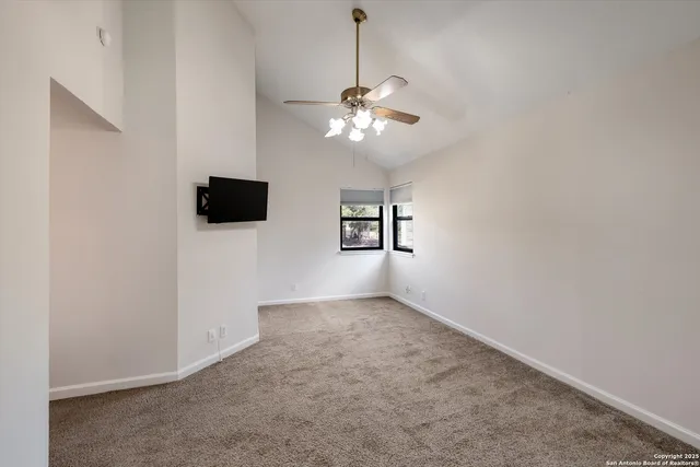 a view of an empty room with a fan