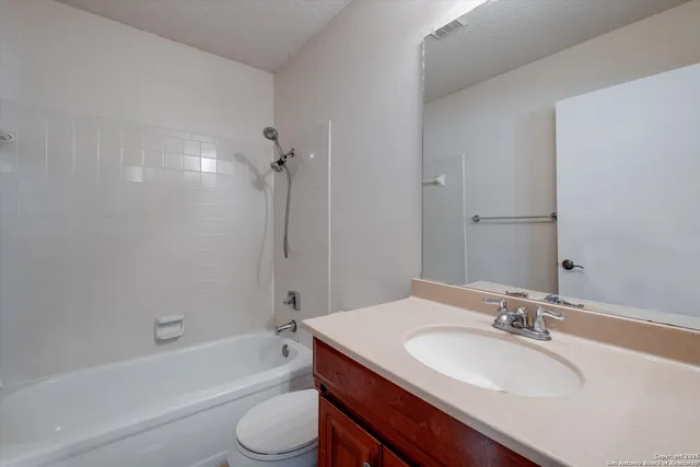 a bathroom with a sink a toilet a bathtub and shower