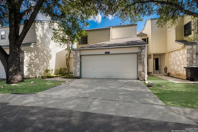 a view of a house with a yard and garage