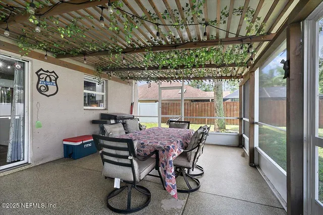 a dining room with furniture and a garden view