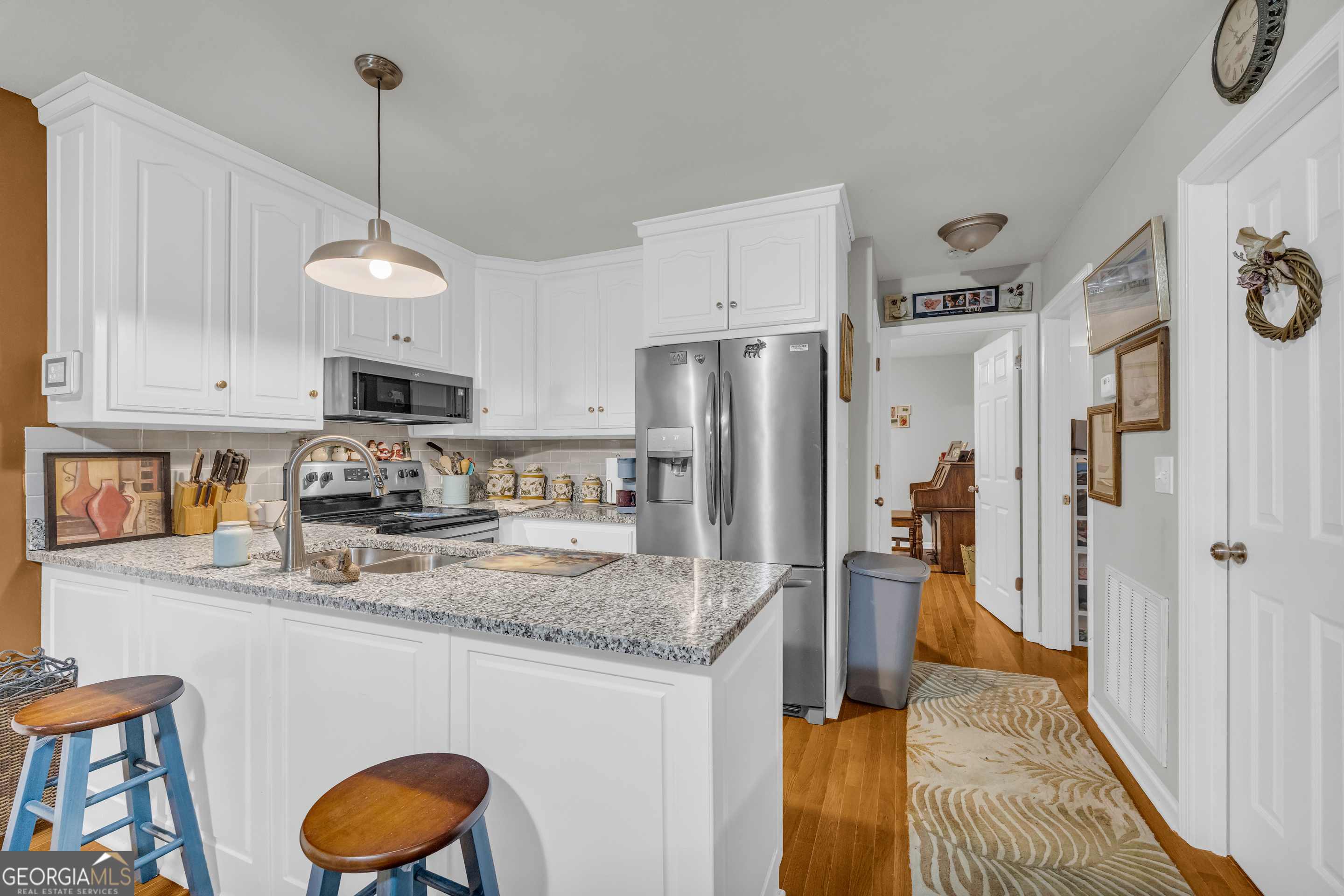 26 Chief Lane Hartwell, GA 30643 - Photo 21 of 65 a kitchen with stainless steel appliances granite countertop a sink a refrigerator a stove a washer and dryer