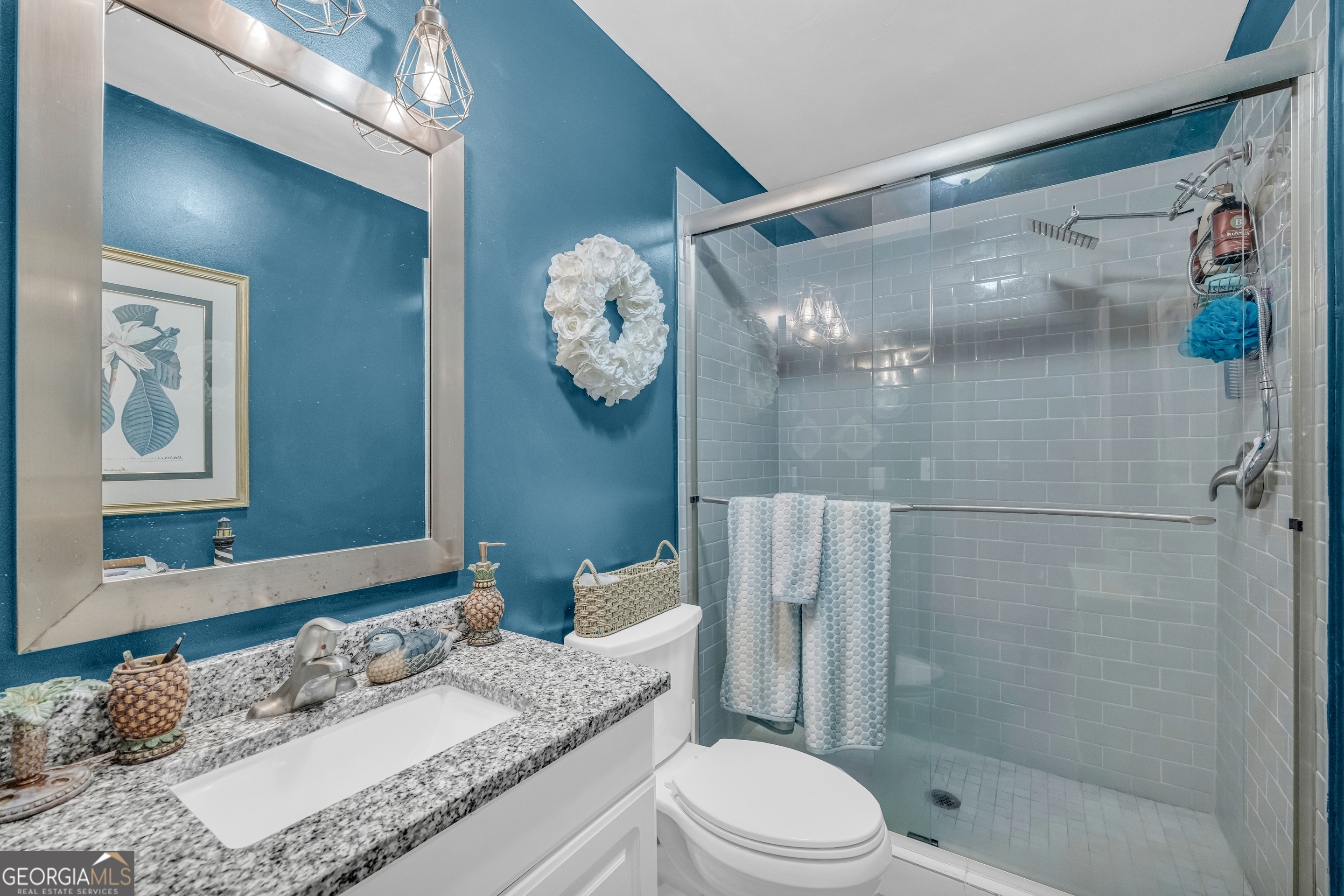 26 Chief Lane Hartwell, GA 30643 - Photo 27 of 65 a bathroom with a granite countertop sink mirror toilet and shower